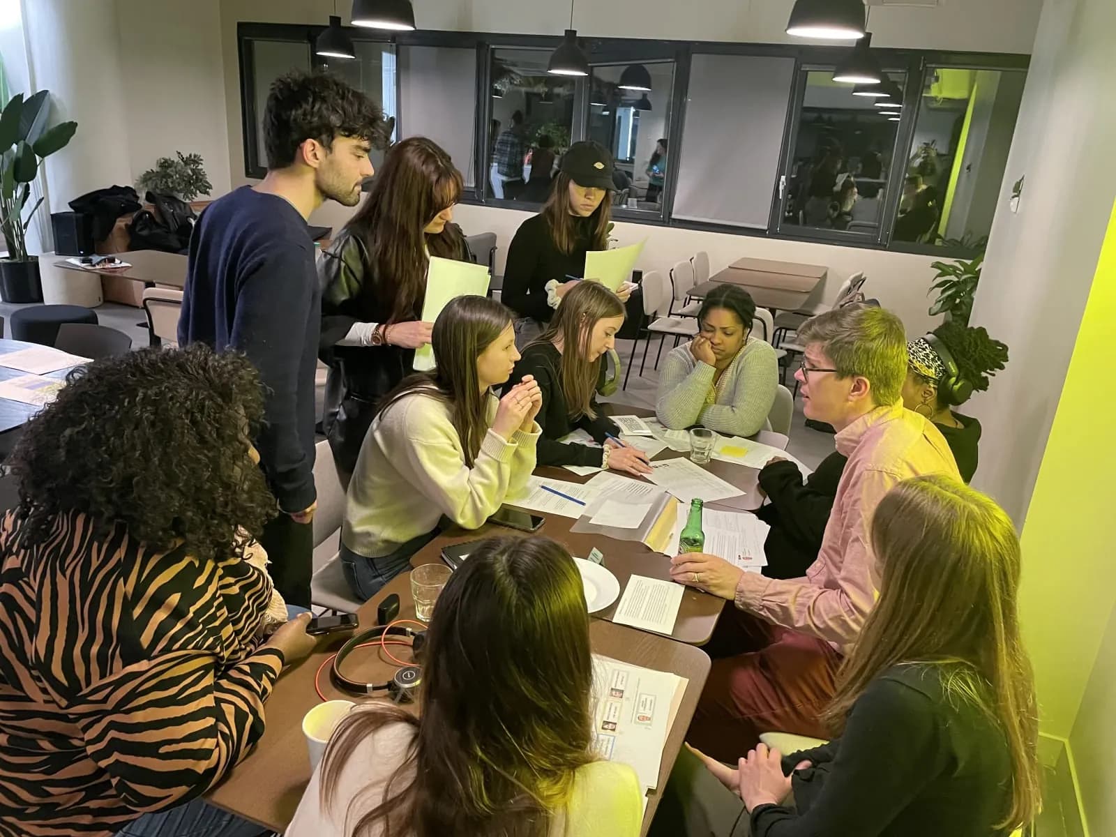 Case files and clues spread on a table for a team investigation