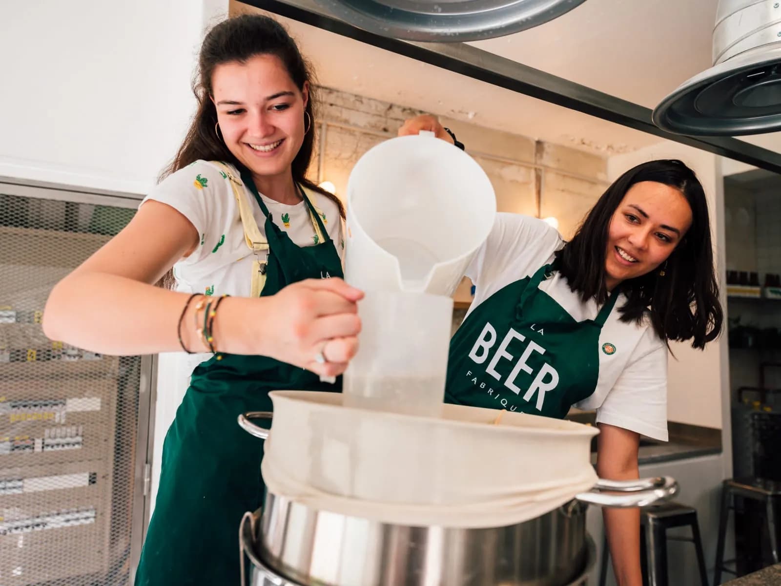 Participants preparing fermented drinks during a team workshop in Paris