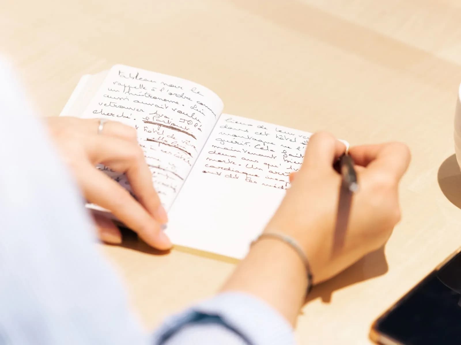 Colleagues writing together during a collaborative writing workshop in Paris