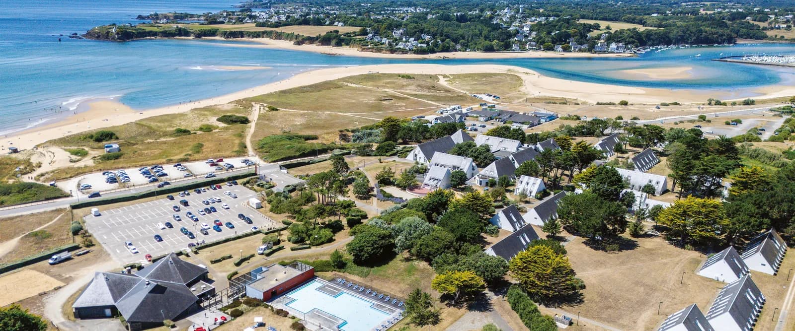 Aerial view of Domaine des Dunes Océanes on the Breton coast, with the sandy beach, estuary and resort buildings