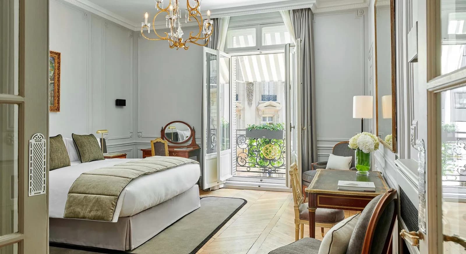 Bedroom with balcony doors and a view over the street at Hôtel Lancaster Paris, 8th arrondissement