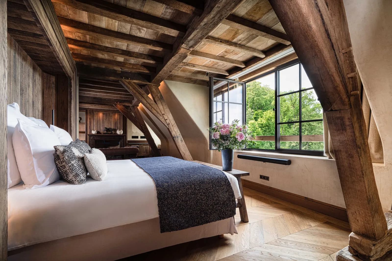 Suite with exposed timber beams and a bright dormer window at La Ferme Saint-Siméon, Honfleur