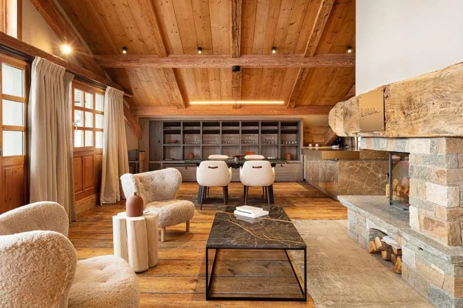Illuminated chalet facade with a wooden balcony at night, Le Chabichou, Courchevel 1850