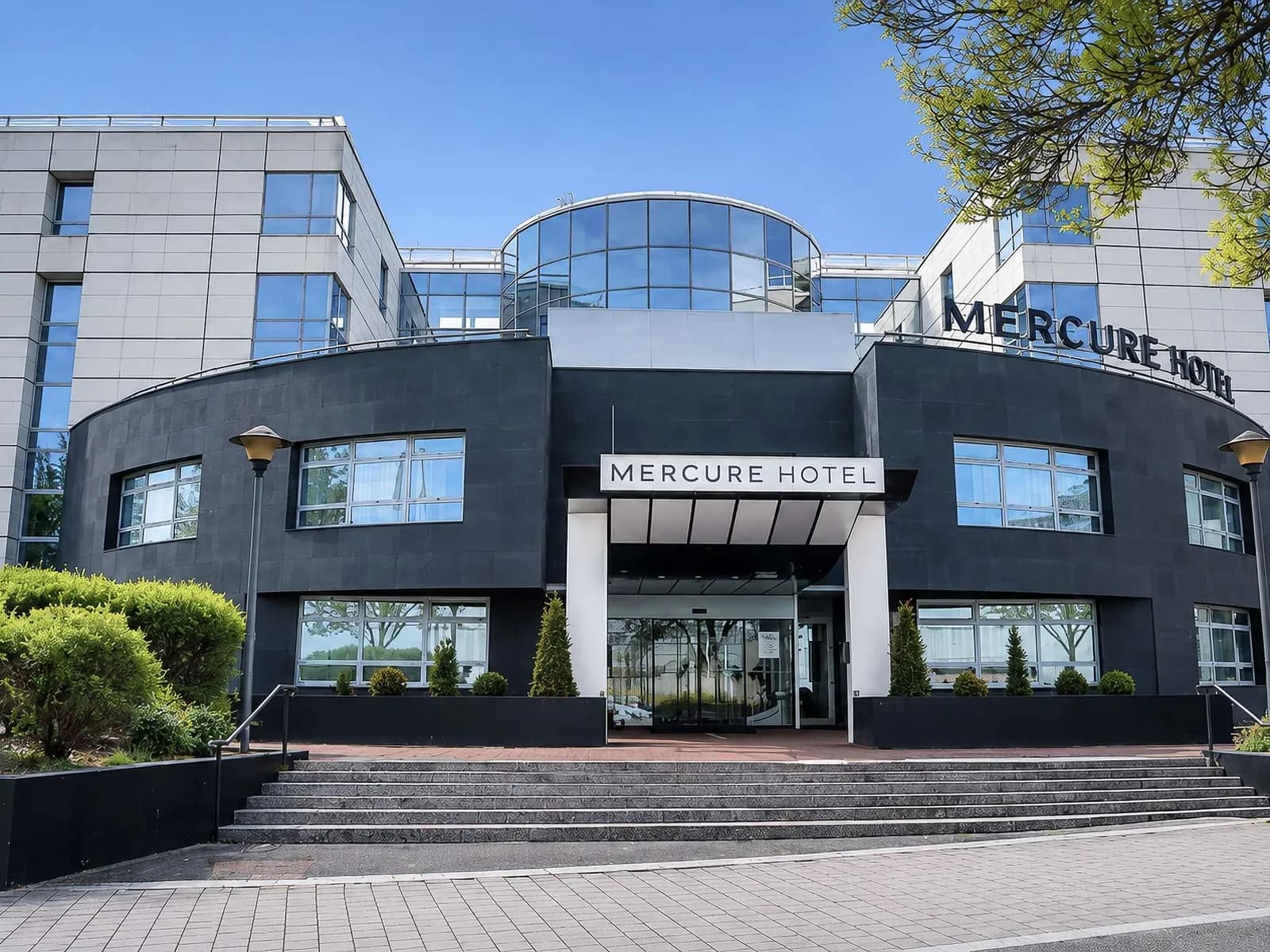 Front facade and entrance steps of the Mercure Paris Massy Gare TGV hotel in Massy, Essonne