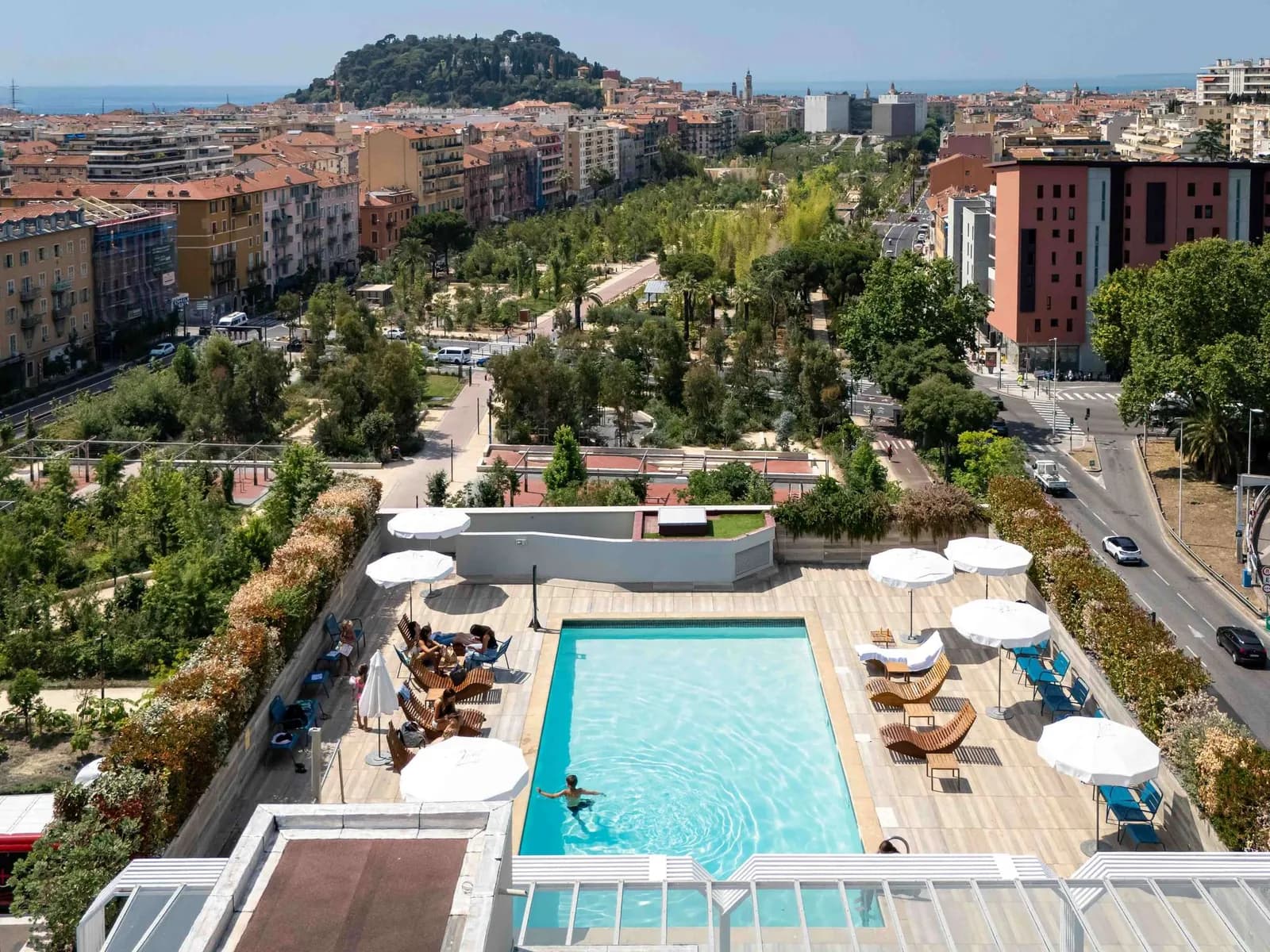 Rooftop pool and sun loungers with views over the hills of Nice at Novotel Nice Centre Vieux Nice