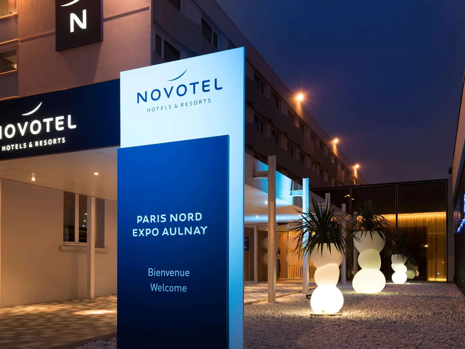 Entrance of Novotel Paris Nord Expo Aulnay with the illuminated Paris Nord Expo Aulnay sign