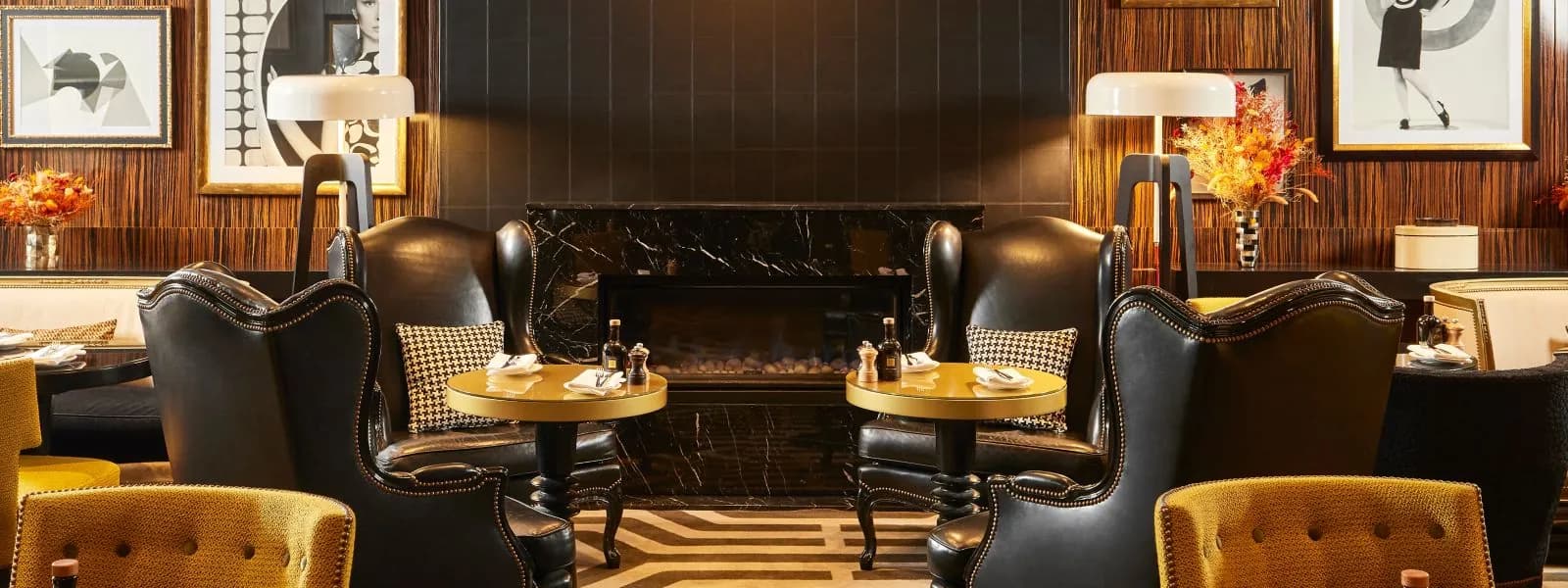 Lounge bar with dark wood panelling, leather chairs and gold armchairs at Sofitel Paris Le Faubourg
