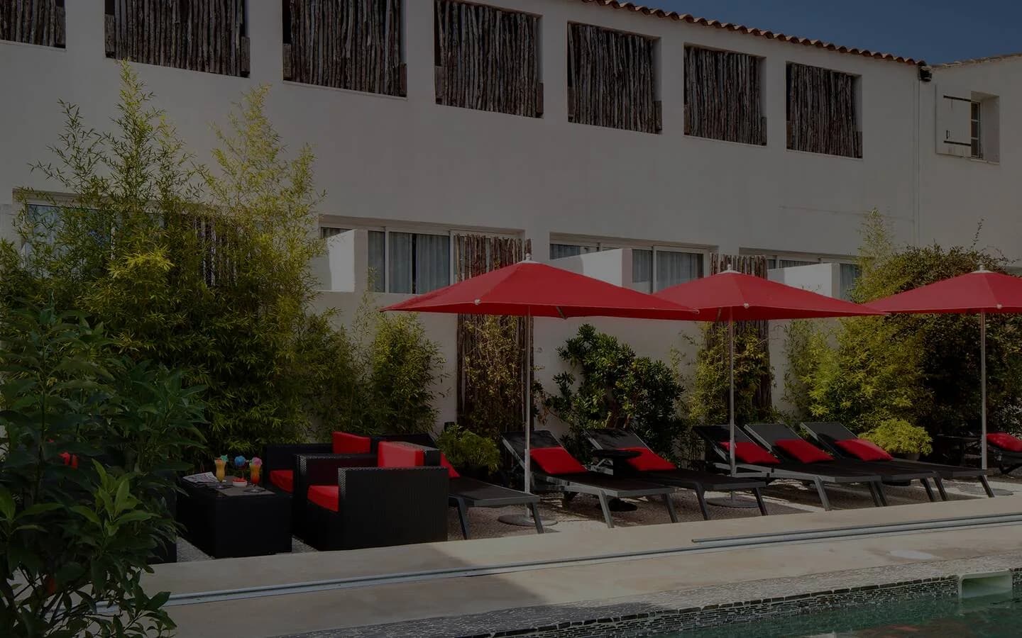 Terrace with red parasols and pool of Vila de la Mar hotel, Saintes-Maries-de-la-Mer