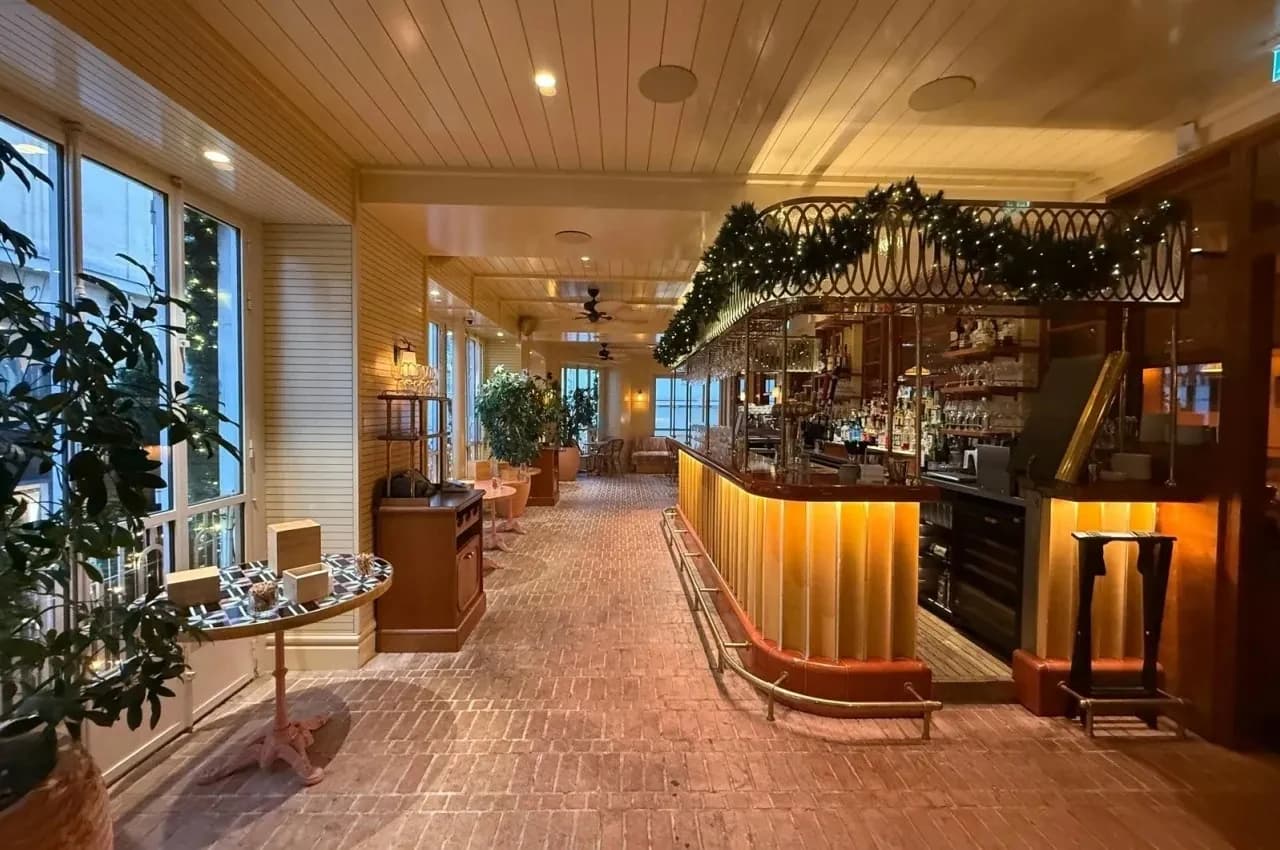 Loggia with a garland-decorated bar and dining tables