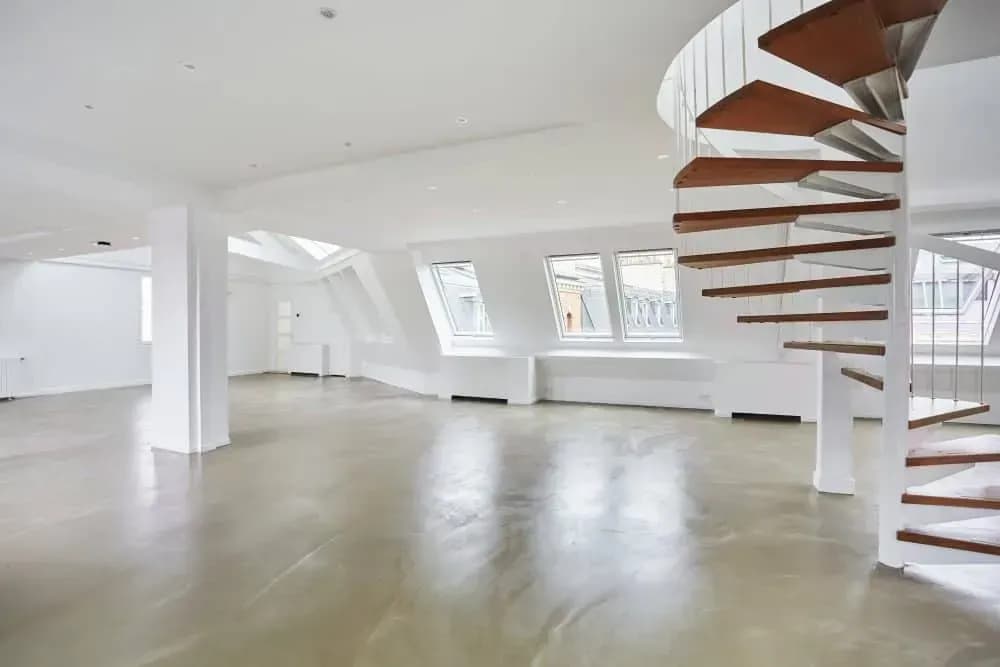 Loft with a spiral staircase and a wooden terrace