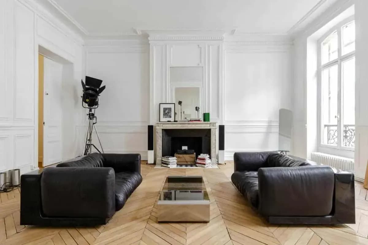 White salon with wall mouldings and antique fireplace, Paris 8e