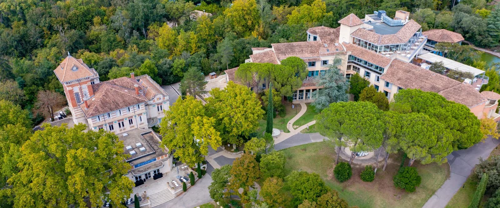 Aerial view of Domaine des Platanes du Vaucluse, with its main building, gardens and wooded park in Provence