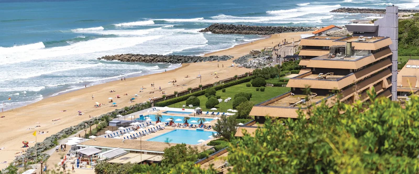 Aerial view of Domaine des Rivages Basques, a seaside seminar resort with pools, lawns and the Atlantic beach