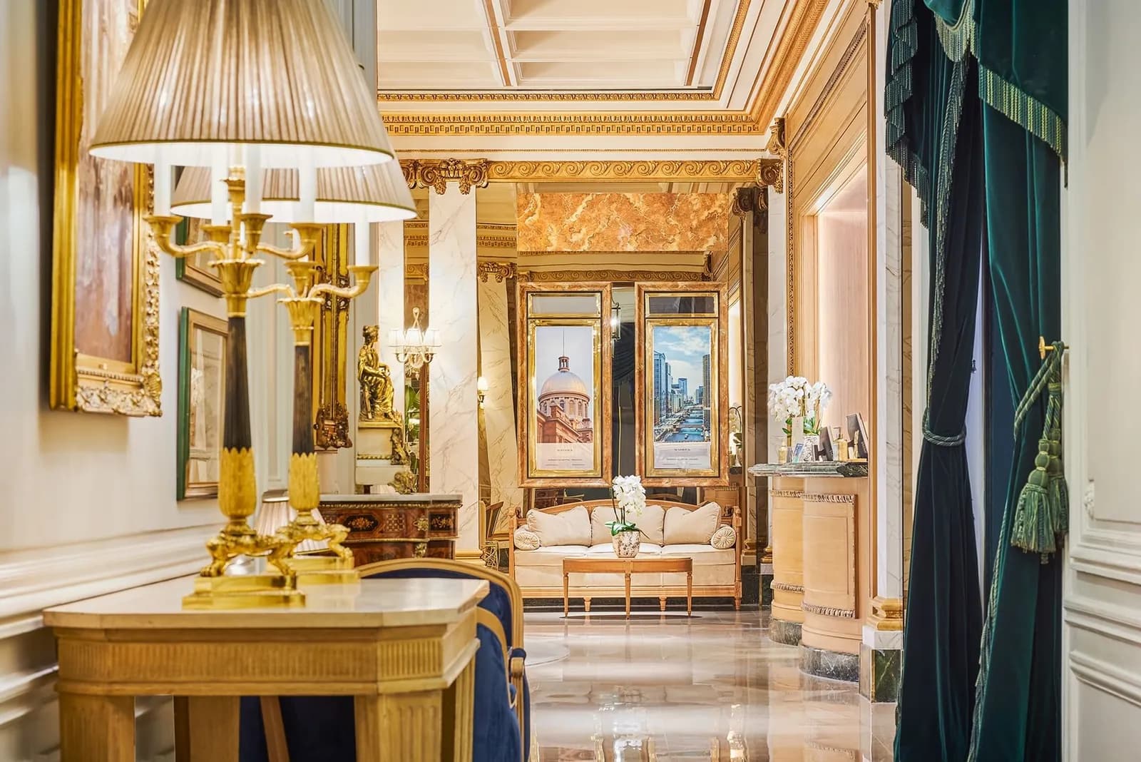 Ornate lobby of Hôtel Westminster in Paris with gilded columns, gold table lamps and framed paintings