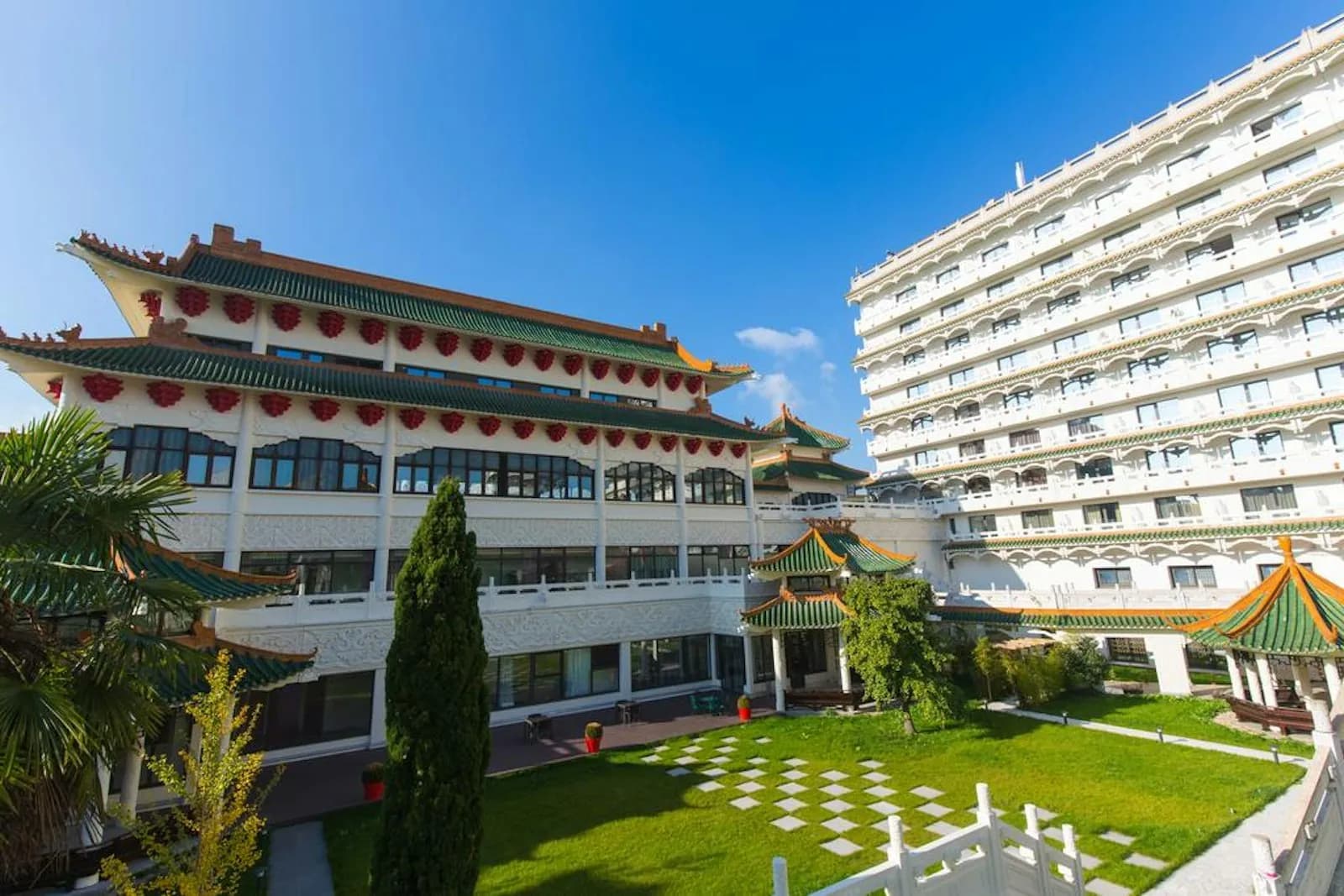 Courtyard and garden of the Huatian Chinagora Hotel in Alfortville, with its Chinese-style pavilions and lawn