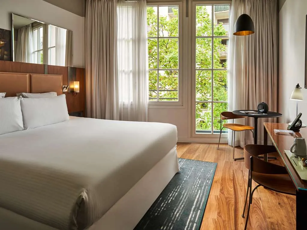 Guest room at Boutet Bastille Hotel Paris in Paris 11th, with a king bed, tall windows and warm wood floors