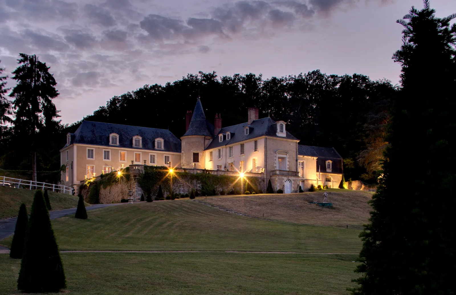 Château de Beauvois lit up at dusk, a historic château hotel in the Loire Valley