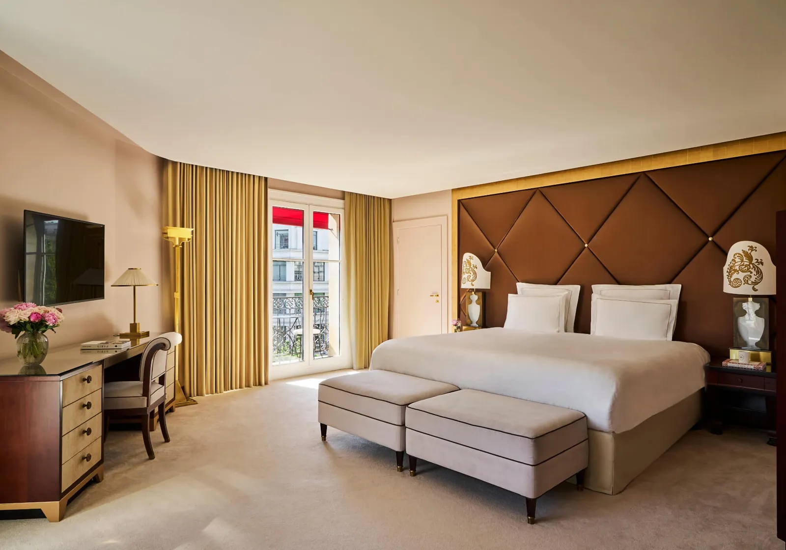 Deluxe bedroom with a tufted headboard and brown leather panels at Fouquet's Paris hotel
