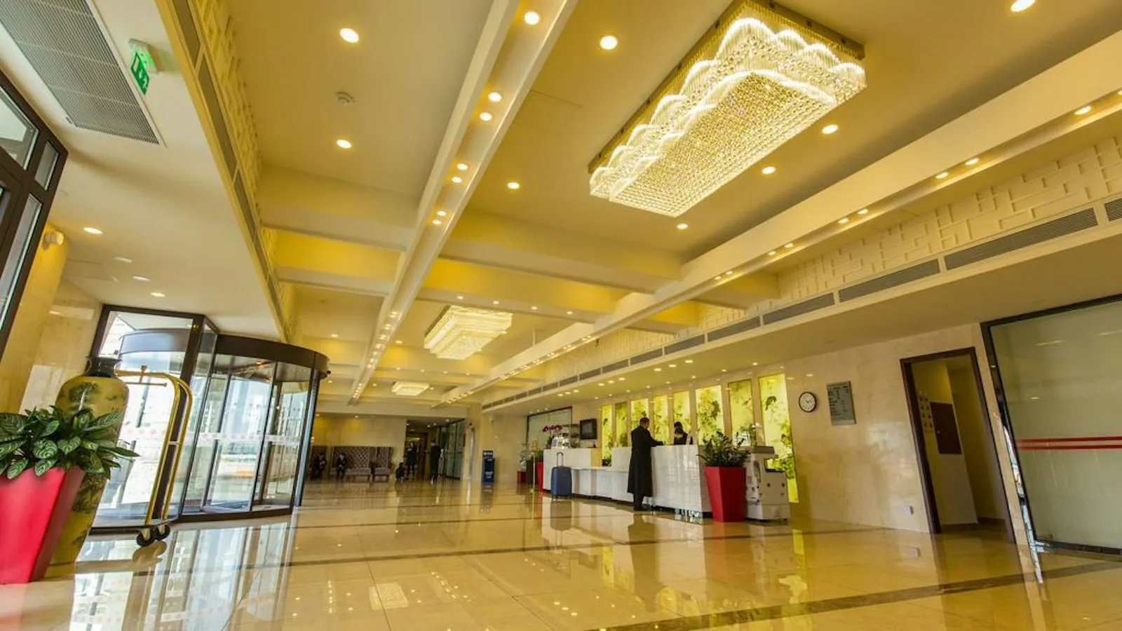 Reception hall with a crystal ceiling light and gold-toned walls at Huatian Chinagora Hotel, Alfortville