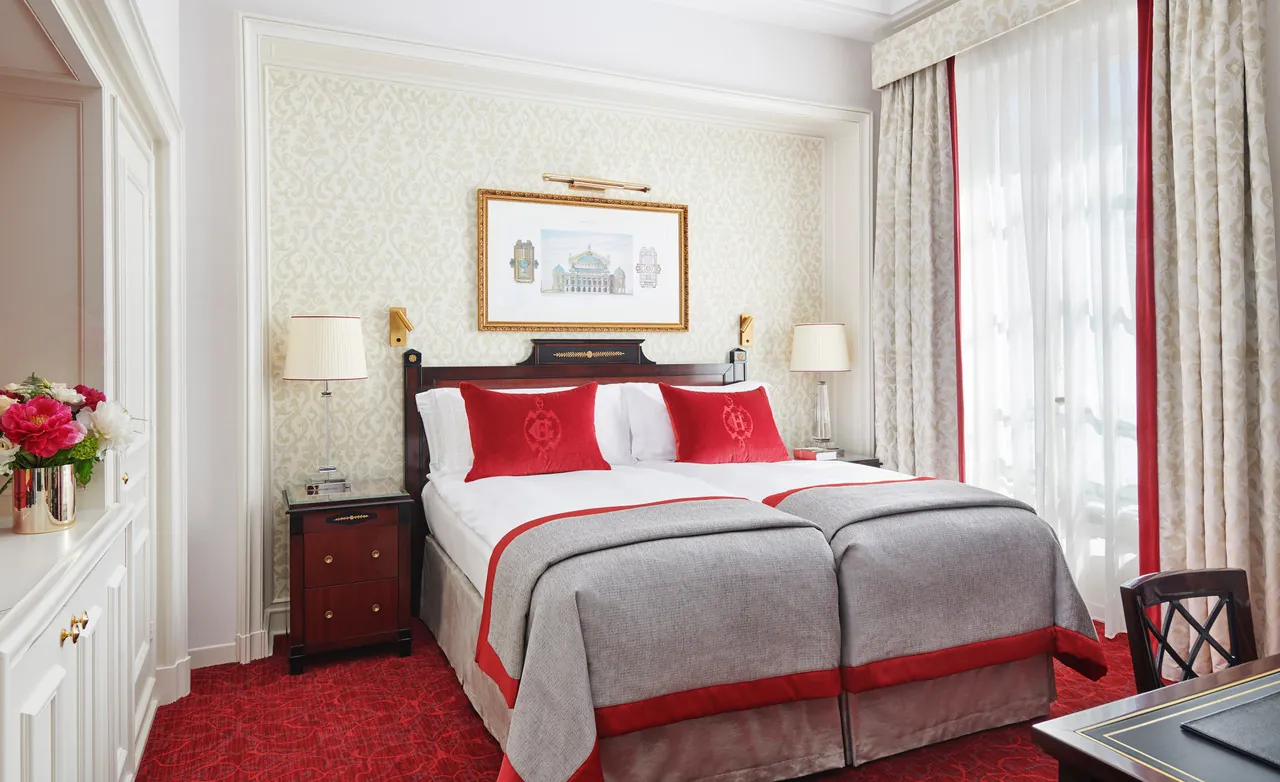 Classic room with red bedding and a gilded picture above the bed at InterContinental Paris Le Grand, Paris