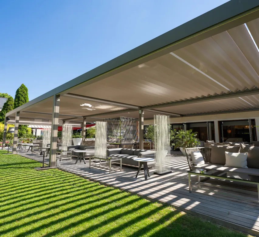 Pergola-covered outdoor terrace on the lawn at L'Assiette Champenoise, Tinqueux near Reims
