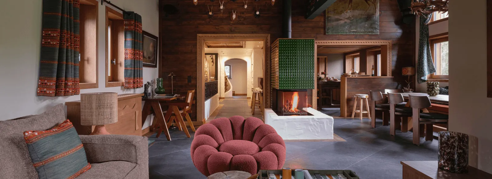Cosy lounge with a fireplace and armchairs at the Les Fermes de Marie hotel in Megève