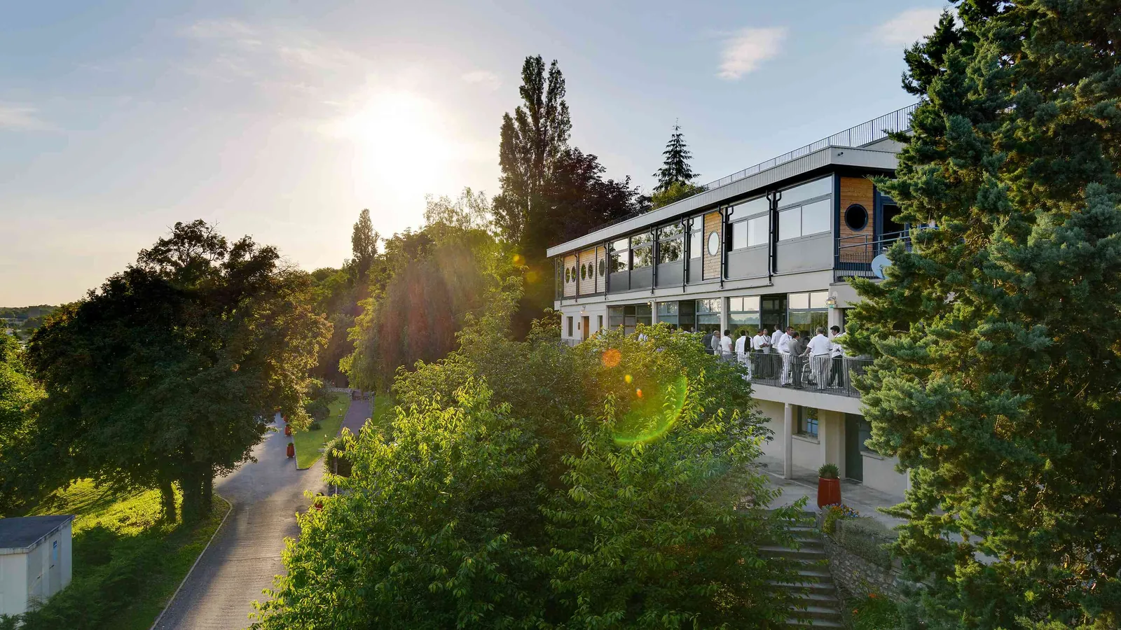 Campus building at sunset among mature trees at Les Jardins du Fleuve, Seine-et-Marne, near Paris