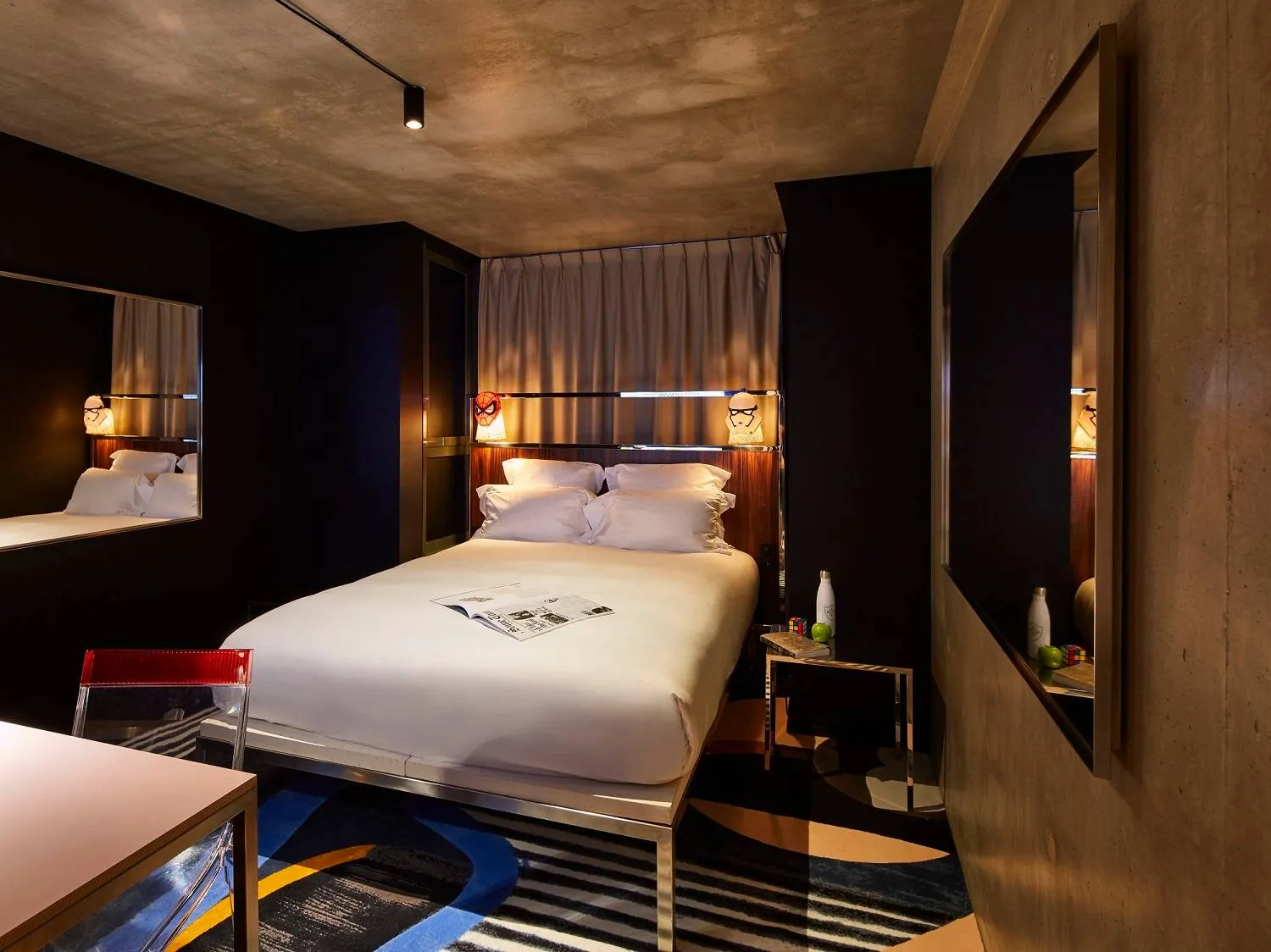 Design bedroom with dark walls and warm lighting at Mama Shelter Paris East, Paris