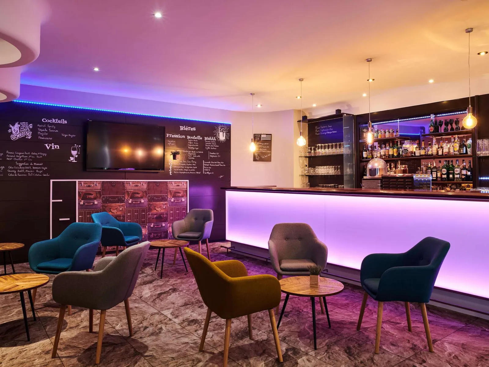Lounge bar with purple-lit counter and teal armchairs at Mercure Rennes Centre Gare
