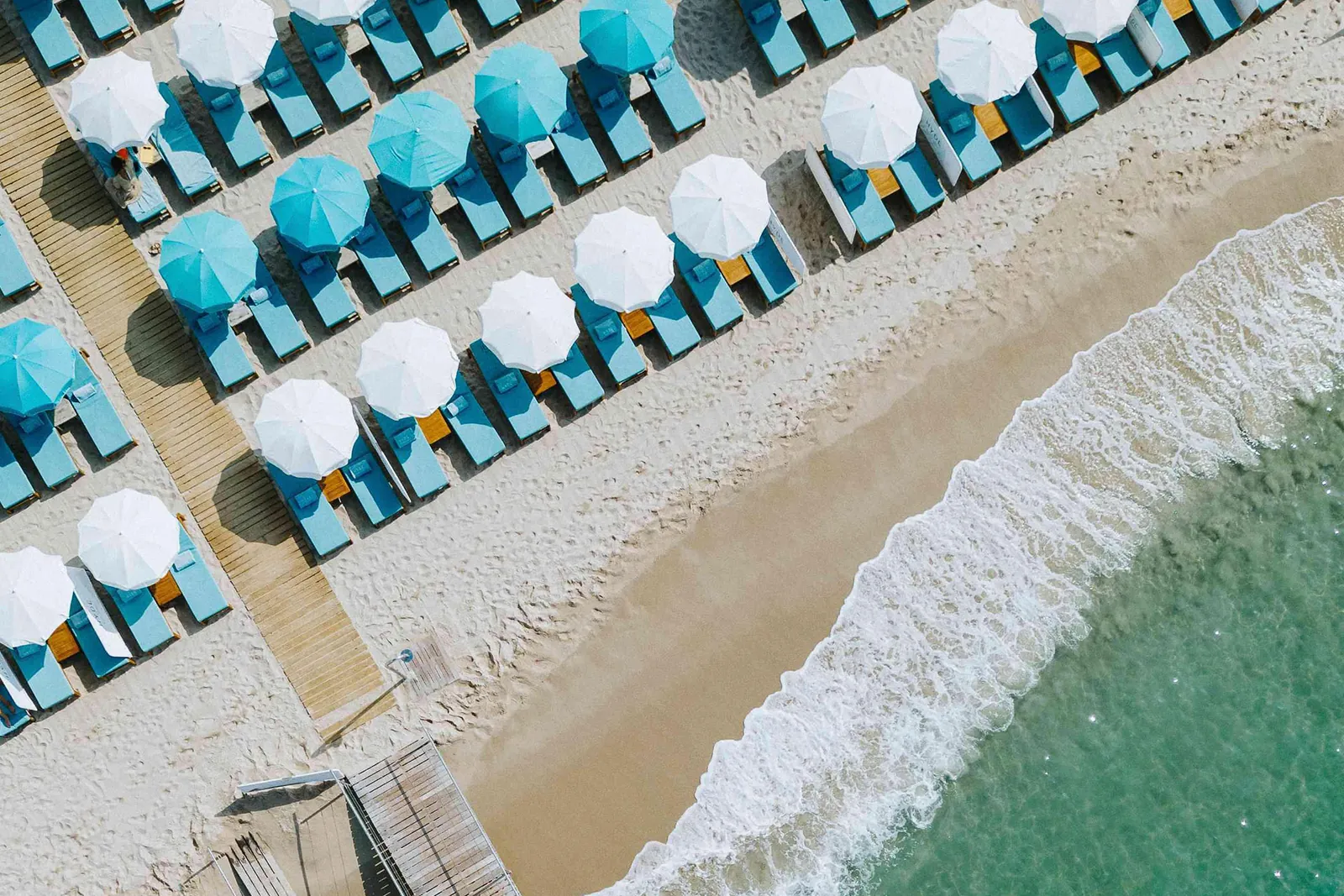 Aerial view of the beach sunloungers and turquoise sea in front of Mondrian Cannes, Cannes