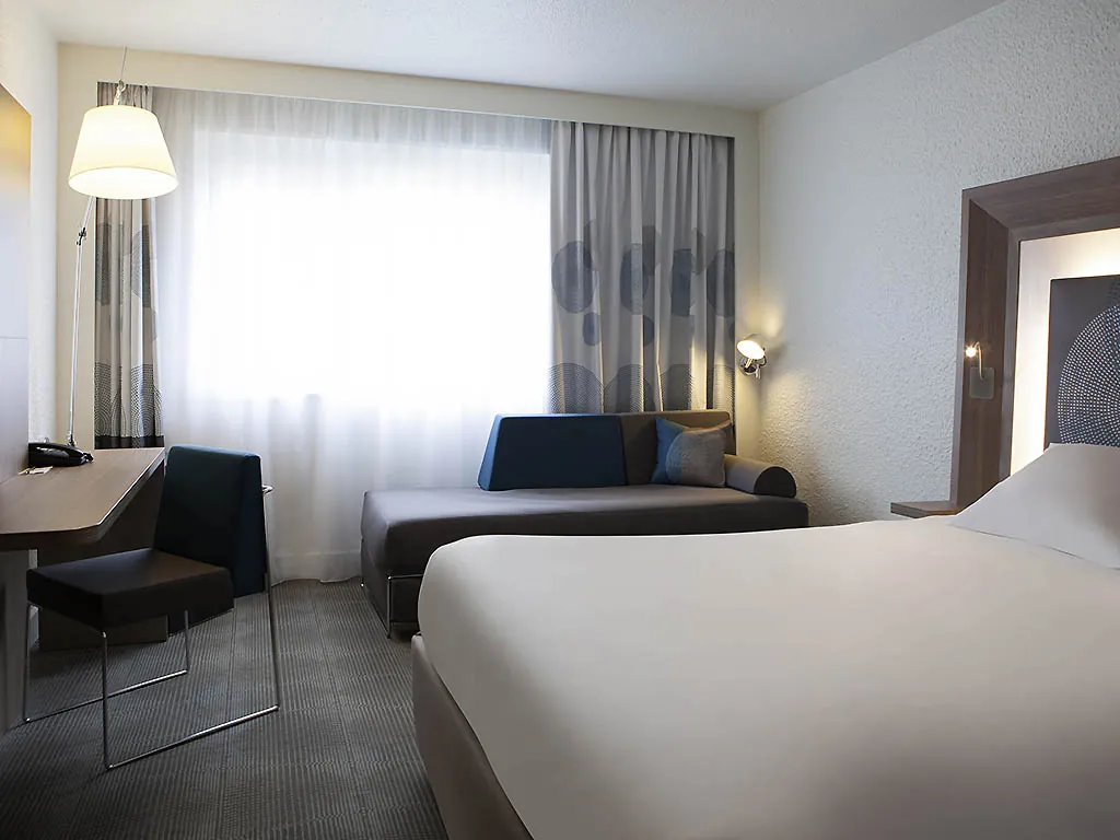 Classic room with a double bed and a sofa bed at Novotel Fontainebleau Ury, near Fontainebleau