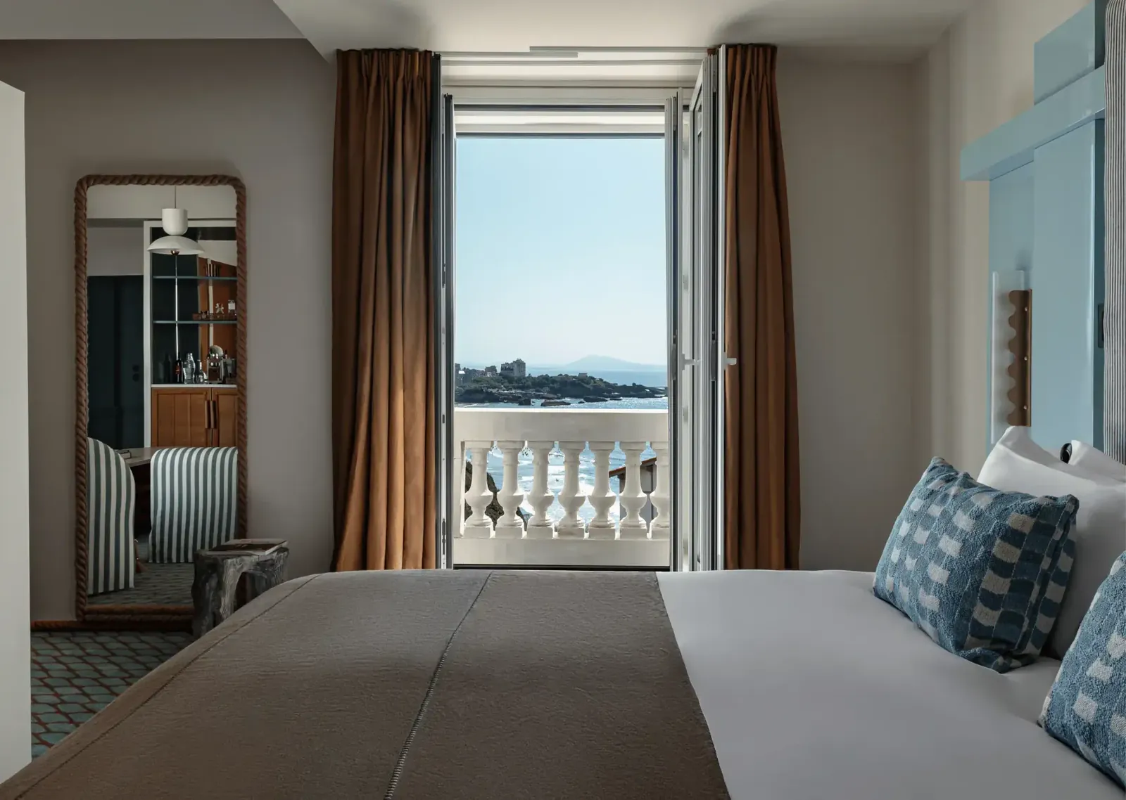 Guest room with a view of the sea through open doors at Régina Experimental, Biarritz