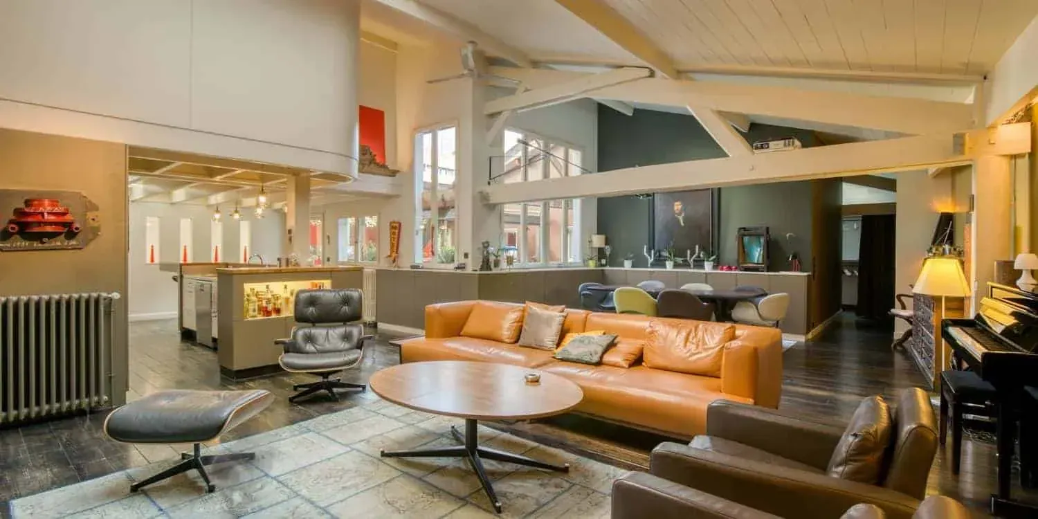 Loft with exposed beams and a kitchen bar