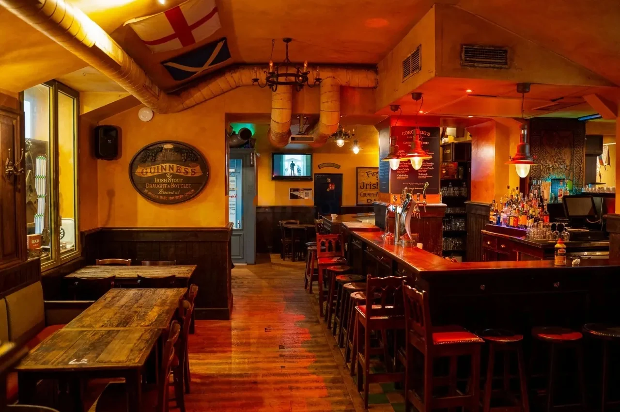Bar counter with tall stools and wooden panelling