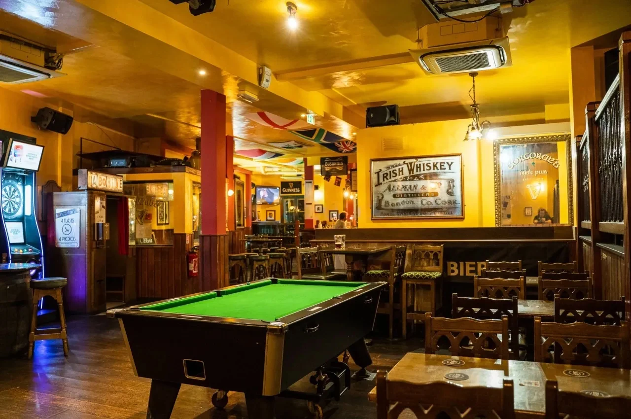 Pool table beside Irish whiskey signage