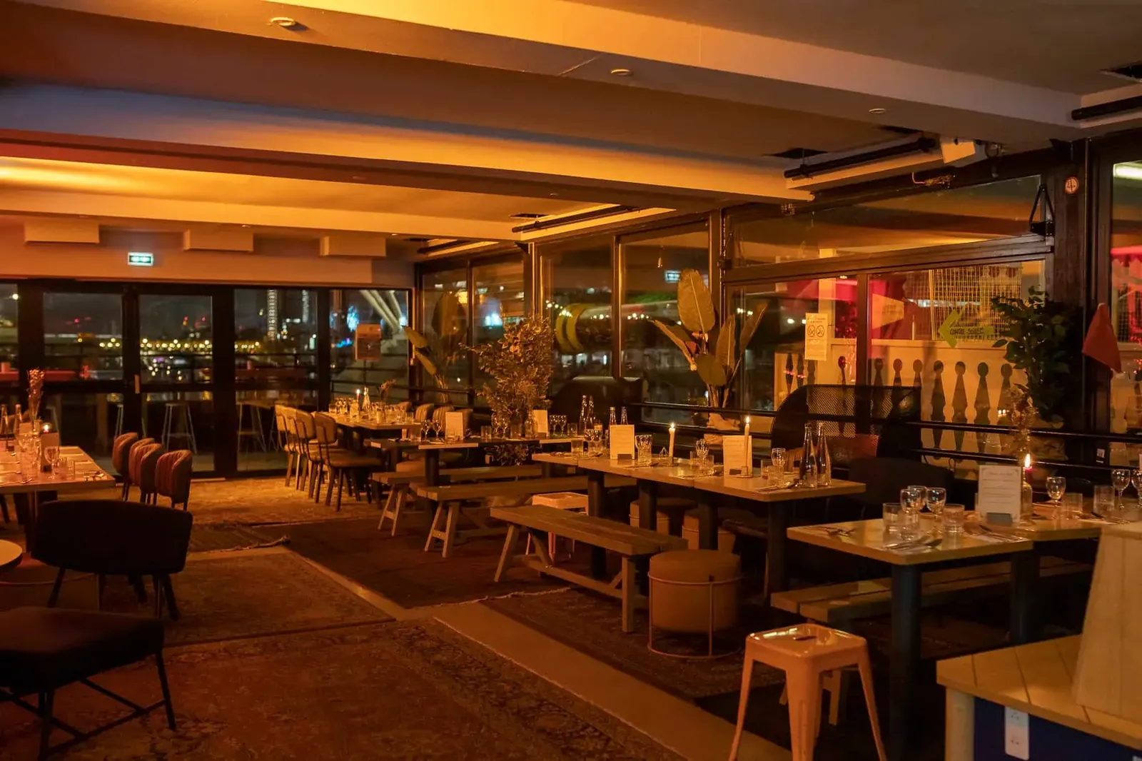 Barge interior with wooden pallet furniture and warm lighting