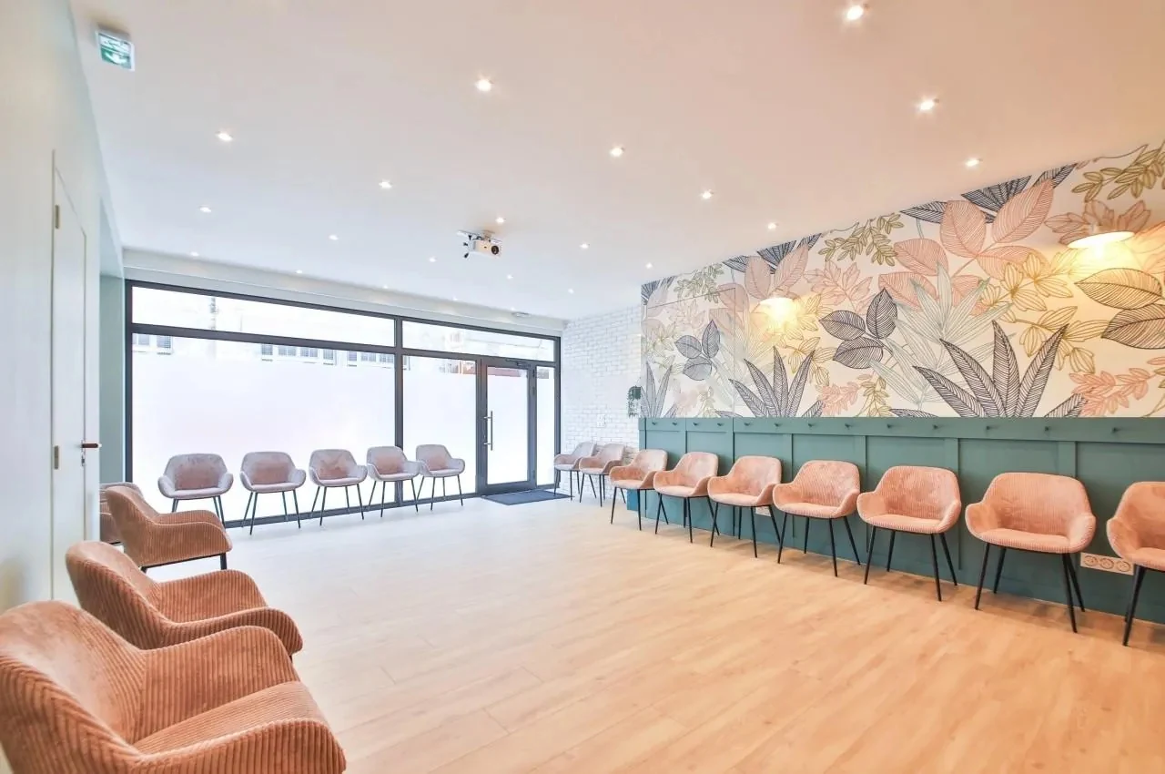 Second room with pink chairs beside a glass wall