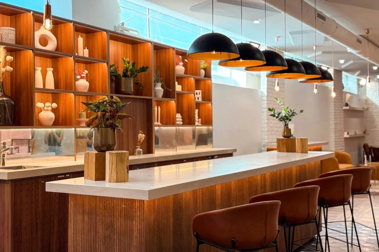 Bar counter with wood shelving and pendant lights