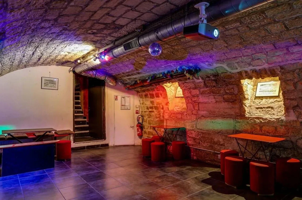 Staircase and bar area beside stone walls
