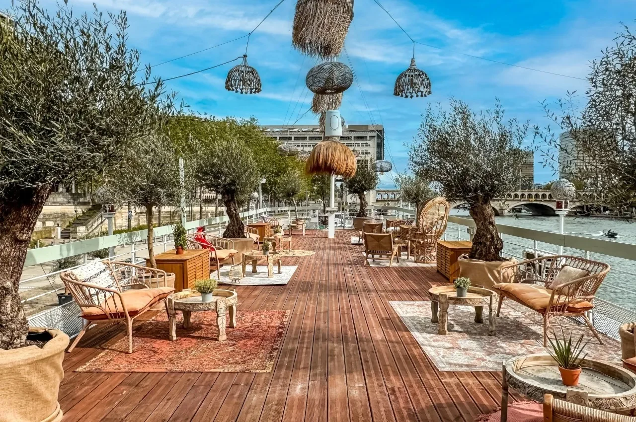 Quayside terrace with olive trees and rugs