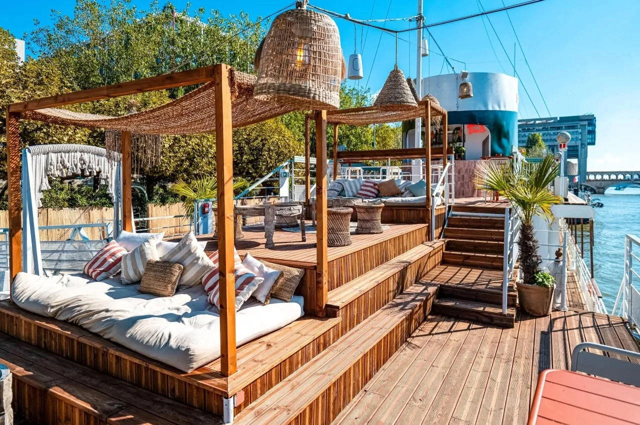 Lounge deck with daybeds and a wooden canopy