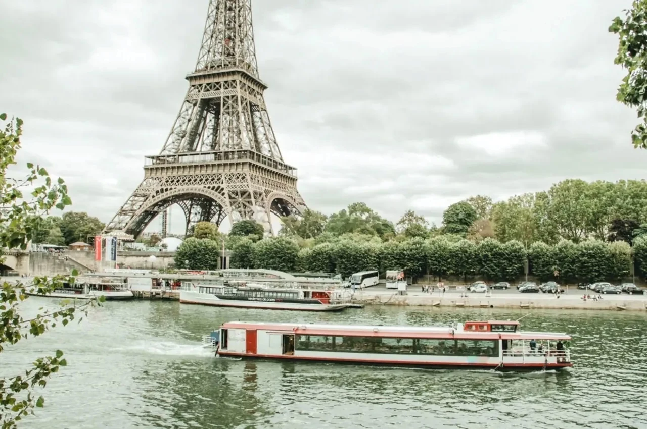 View of the Eiffel Tower from the Seine, with a river boat