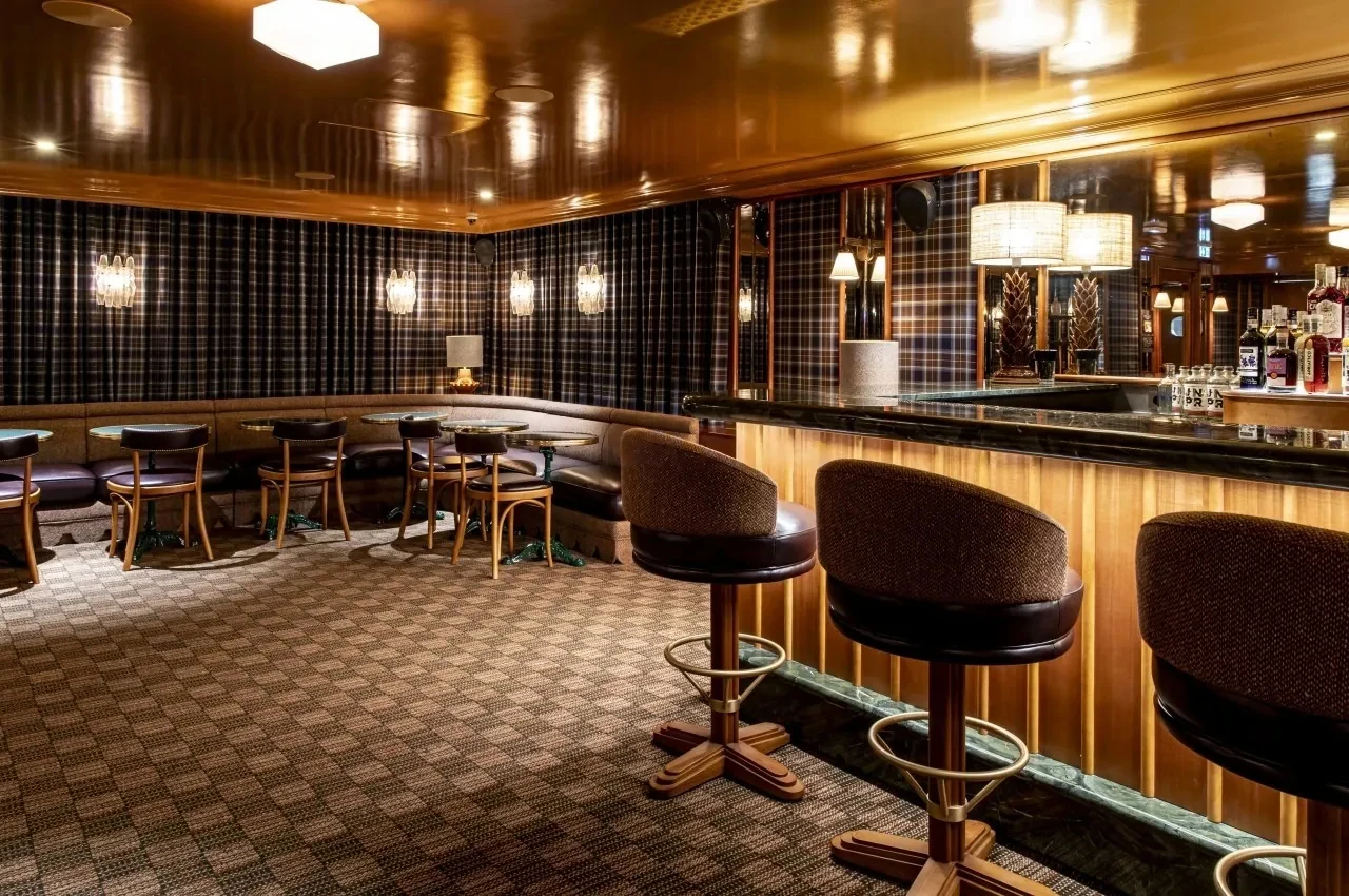 Basement bar with checked panelling and high stools