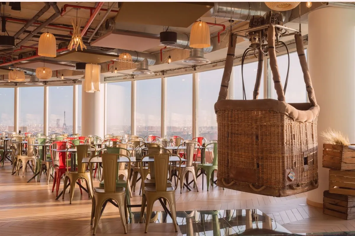 Rooftop room with a hot-air balloon basket hanging above the tables