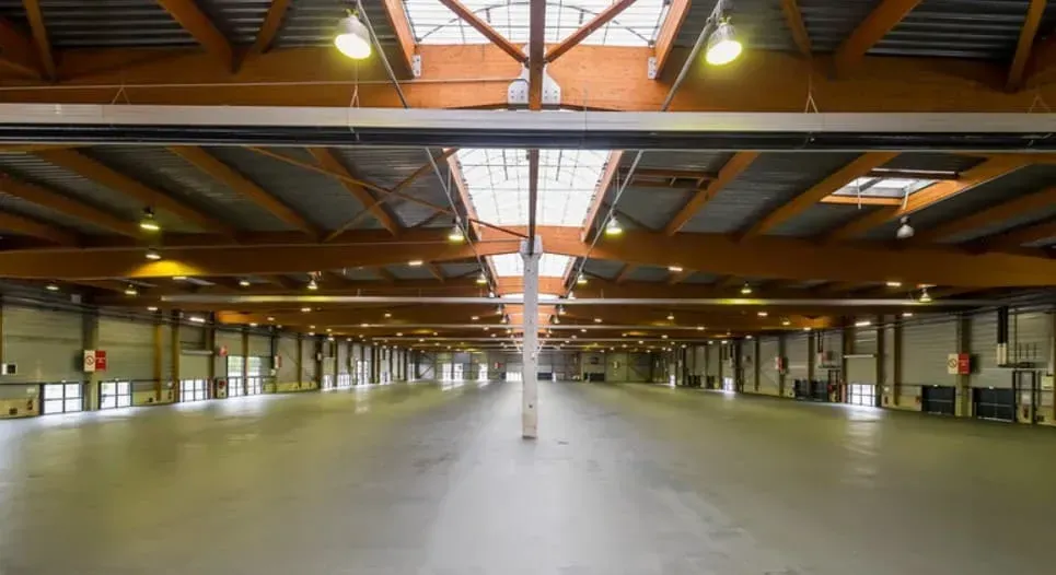 Large industrial hall with a skylight and a bare concrete floor