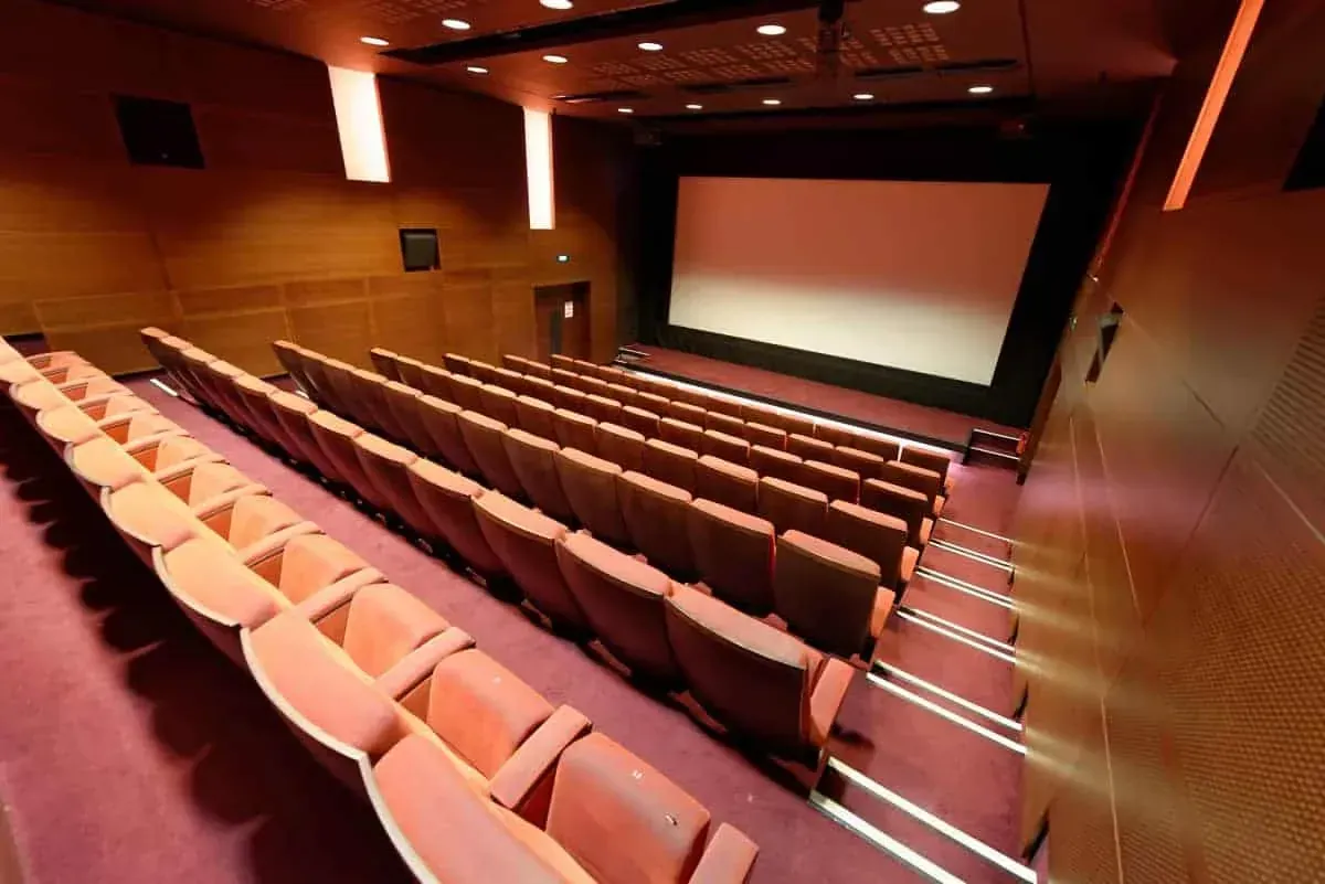 Side view of the tiered seating and the screen at the end of the room